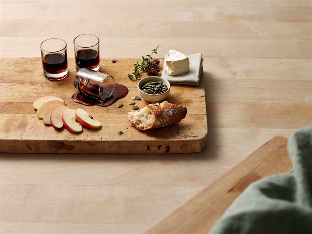Tasting board with oil glasses, bread, apple and cheese